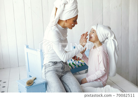 Mom playing with cosmetics with her daughter Mom playing with cosmetics with her daughter 70082511