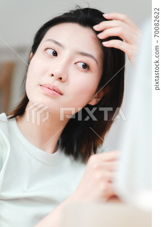 Young beautiful oriental young women at home daily 70082622