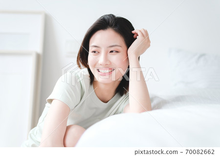 Young beautiful oriental young women at home daily Young beautiful oriental young women at home daily 70082662