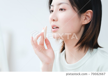 Young beautiful oriental young women at home daily 70082667
