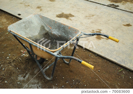 A used empty unicycle for construction at the construction site A used empty unicycle for construction at the construction site 70083600