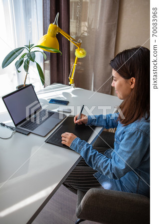 woman working on laptop at home office woman working on laptop at home office 70083968