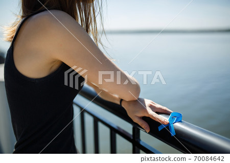 blue ribbon in hands of the girl blue ribbon in hands of the girl 70084642