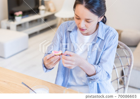 Young woman eating figs 70086603
