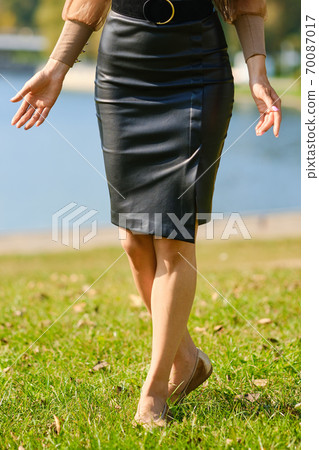 Cropped image of female legs on the grass in the park 70087017
