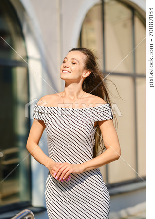 Portrait of young woman in striped dress Portrait of young woman in striped dress 70087033
