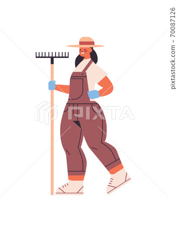 female farmer in uniform holding rake eco farming agricultural industry concept female farmer in uniform holding rake eco farming agricultural industry concept 70087126