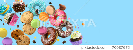 Confectionery and sweets collage. Donuts, cupcakes, cookies, macarons flying over blue background. Confectionery and sweets collage. Donuts, cupcakes, cookies, macarons flying over blue background. 70087673
