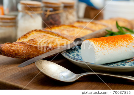 French cheese and fresh baguette on a wood cutter French cheese and fresh baguette on a wood cutter 70087855