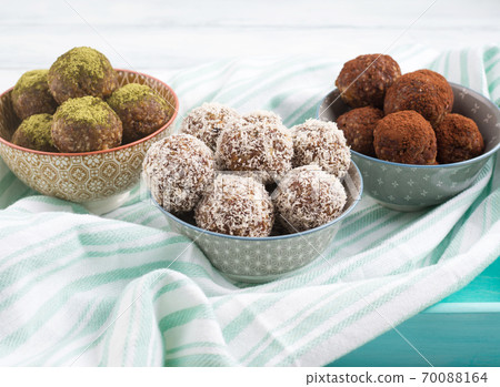 Three different taste energy balls in bowls 70088164