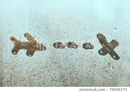 Abstract airplane with trail following on fogged window 70088373