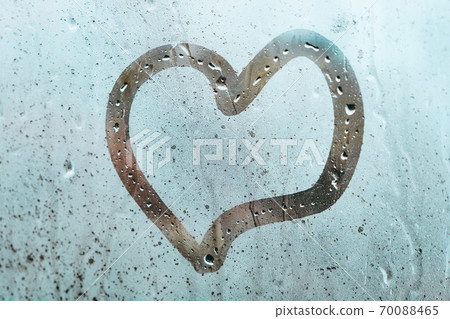 Abstract heart as a symbol of love on a misted window 70088465