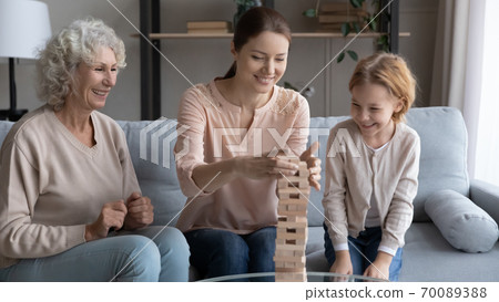 Happy family playing funny board game, enjoying leisure time 70089388