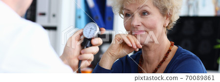 Smiling elderly lady in blue blouse Smiling elderly lady in blue blouse 70089861