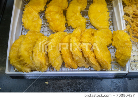 Fried sweet potatoes on rack for sale at food stall Fried sweet potatoes on rack for sale at food stall 70090457