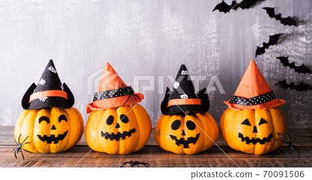 Orange ghost pumpkins with witch hat on gray wooden board background with bat. halloween concept. 70091506