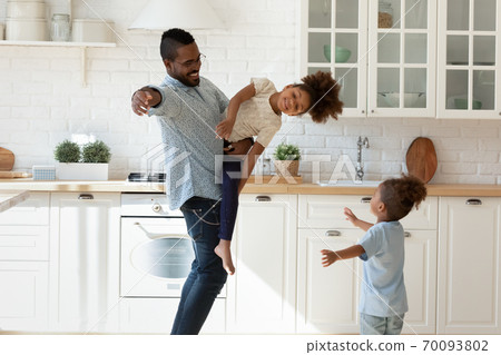 Emotional multiracial family enjoying daycare weekend indoors. Emotional multiracial family enjoying daycare weekend indoors. 70093802