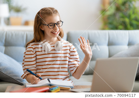 Girl doing homework or online education. Girl doing homework or online education. 70094117