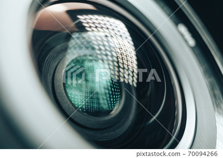 Close up beautiful camera aperture lens with multi colored light glass reflection. Macro view. 70094266