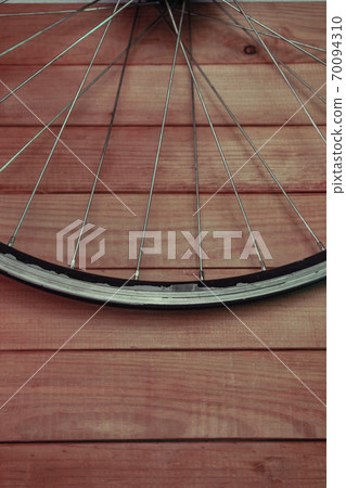 Close up bicycle parts on a red wooden background. 70094310