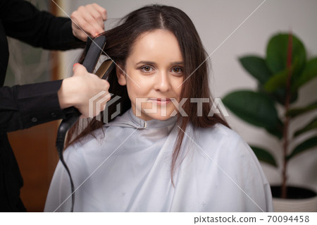 Professional hairdresser working with young woman in beauty salon. Professional hairdresser working with young woman in beauty salon. 70094458