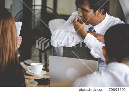 Group of business people meeting in conference room brainstorming consult business document graph 70095801