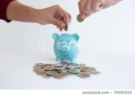 Both male and female businessmen are helping to bring the dollar into the piggy bank to save and prepare for future shortages,Financial accounting and saving money concept. Both male and female businessmen are helping to bring the dollar into the piggy bank to save and prepare for future shortages,Financial accounting and saving money concept. 70095920