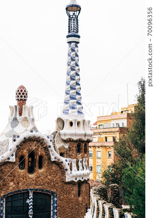 The central entrance to The Park Guell in Barcelona. Gingerbread houses. Right house with a long tower 70096356