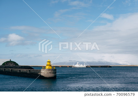 A large yellow lighthouse in Iceland, Reykjavik. 70096579