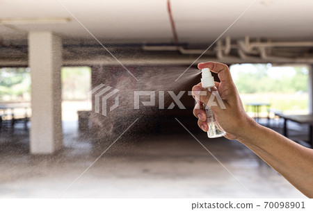 Man uses a spray of alcohol to get rid of bacteria and viruses, Inhibition and prevention of Covid-19 virus, protect virus concept. 70098901