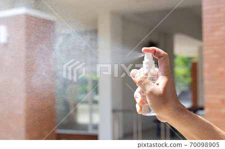 Man uses a spray of alcohol to get rid of bacteria and viruses, Inhibition and prevention of Covid-19 virus, protect virus concept. 70098905