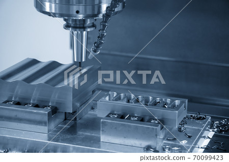 The CNC milling machine cutting the mold parts. The CNC milling machine cutting the mold parts. 70099423