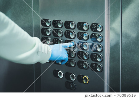 Wearing hand protective gloves in public places during Coronavirus pandemic. Wearing hand protective gloves in public places during Coronavirus pandemic. 70099519