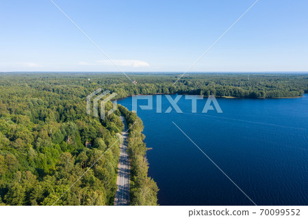 Asphalt freeway through summer forest near lake 70099552