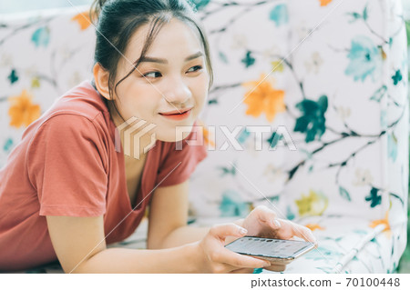 Woman lying on sofa 70100448