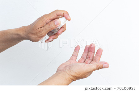 Man uses a spray of alcohol to get rid of bacteria and viruses, Inhibition and prevention of Covid-19 virus, protect virus concept. Man uses a spray of alcohol to get rid of bacteria and viruses, Inhibition and prevention of Covid-19 virus, protect virus concept. 70100955
