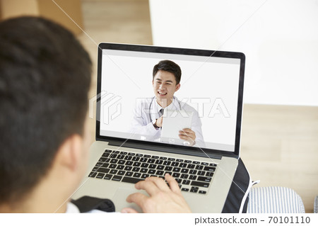young asian man receiving a diagnosis using tele-medicine network 70101110