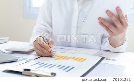 Accounting businessmen are calculating income-expenditure and analyzing real estate investment data, Financial and tax systems concept. Accounting businessmen are calculating income-expenditure and analyzing real estate investment data, Financial and tax systems concept. 70101251