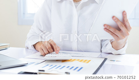 Accounting businessmen are calculating income-expenditure and analyzing real estate investment data, Financial and tax systems concept. Accounting businessmen are calculating income-expenditure and analyzing real estate investment data, Financial and tax systems concept. 70101252