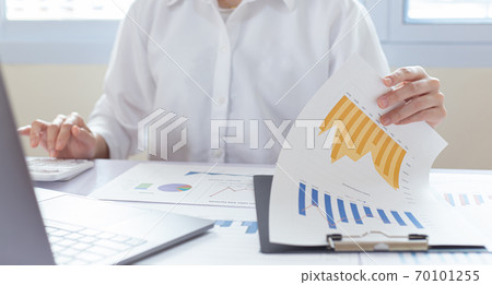 Accounting businessmen are calculating income-expenditure and analyzing real estate investment data, Financial and tax systems concept. Accounting businessmen are calculating income-expenditure and analyzing real estate investment data, Financial and tax systems concept. 70101255
