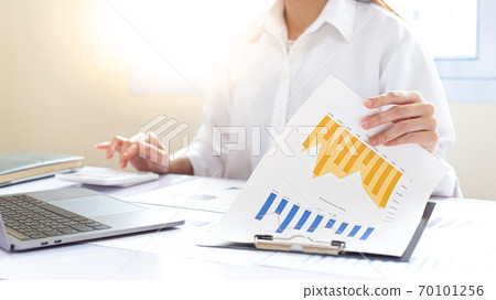 Accounting businessmen are calculating income-expenditure and analyzing real estate investment data, Financial and tax systems concept. Accounting businessmen are calculating income-expenditure and analyzing real estate investment data, Financial and tax systems concept. 70101256