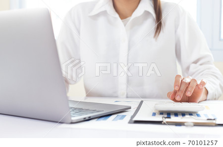 Accounting businessmen are calculating income-expenditure and analyzing real estate investment data, Financial and tax systems concept. Accounting businessmen are calculating income-expenditure and analyzing real estate investment data, Financial and tax systems concept. 70101257