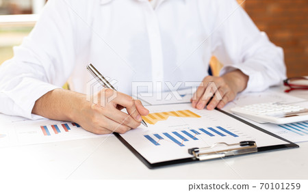 Accounting businessmen are calculating income-expenditure and analyzing real estate investment data, Financial and tax systems concept. Accounting businessmen are calculating income-expenditure and analyzing real estate investment data, Financial and tax systems concept. 70101259