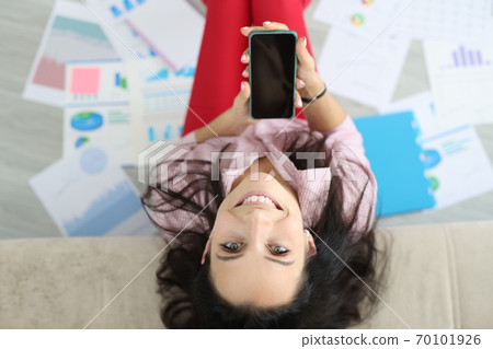 Happy woman sit on floor put her head on sofa. Happy woman sit on floor put her head on sofa. 70101926