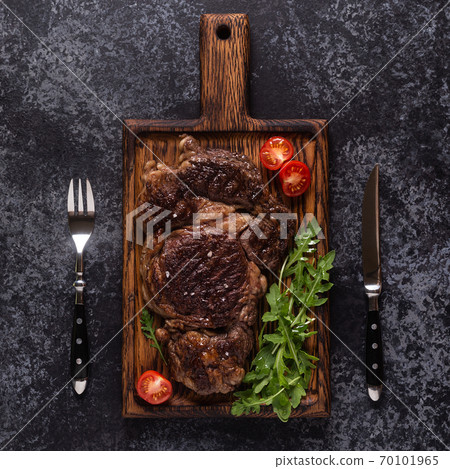 Grilled beef steak with spices on a wooden board. Grilled beef steak with spices on a wooden board. 70101965