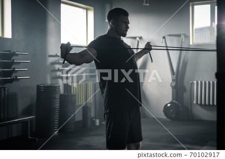 Serious Man Concentrated on Biceps and Triceps Workout . 70102917