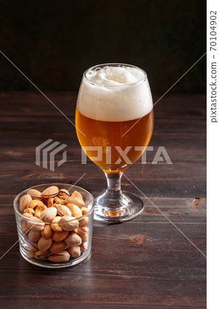 Belgian style beer with nuts Belgian style beer with nuts 70104902