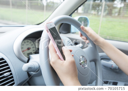 Woman driving while Woman driving while 70105715