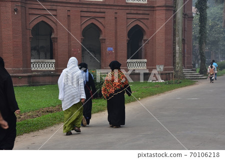 Dhaka, the capital of Bangladesh, a historic building, Curzon Hall, a Muslim woman taking a walk in the morning 70106218