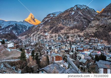 Beautiful view of village in sunrise time with Matterhorn peak background in Zermatt, Switzerland. Beautiful view of village in sunrise time with Matterhorn peak background in Zermatt, Switzerland. 70108900